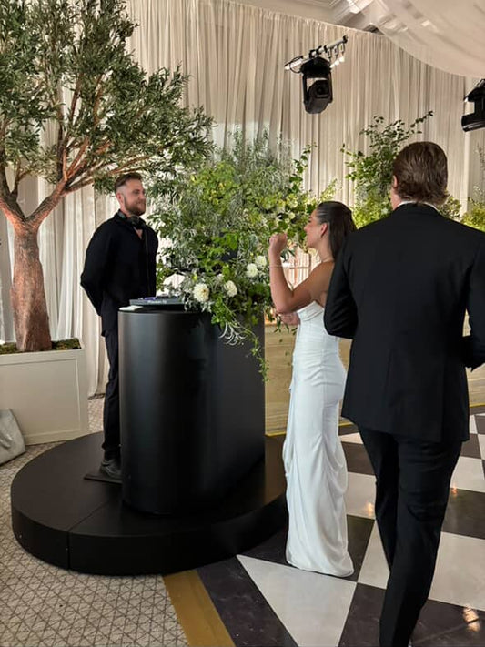 Circular black stage and DJ bar