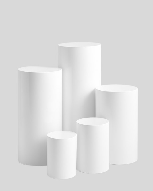 Group of cylindrical plinth pedestals arranged by height, perfect for visual merchandising or event decor.